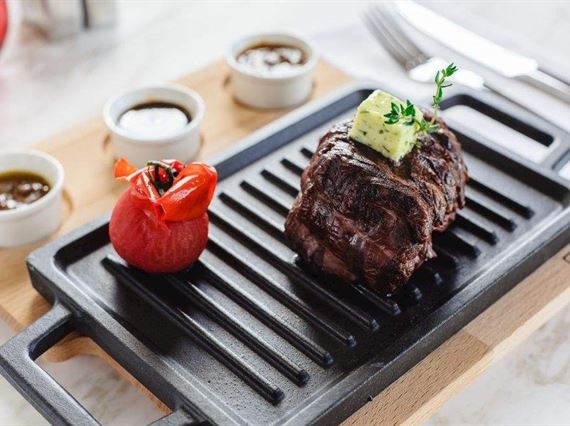 Steak and tomato on grill