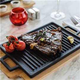 Steak on grill with vegetables