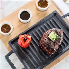 Steak on grill with sauces 