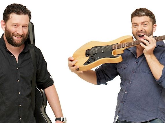 Two guys playing guitar